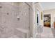 Elegant glass shower with gray and white tile and bench seat features a walk in closet at 8439 Sonata Ct, Denver, NC 28037