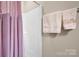 Clean shower area with pink curtain, ensuring a private and refreshing experience at 8439 Sonata Ct, Denver, NC 28037