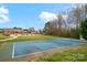 Well-kept tennis court with a glimpse of community pool and building at 8439 Sonata Ct, Denver, NC 28037