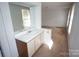 Bright bathroom with a clean white vanity, sink, and a large mirror reflecting natural light at 8915 Touchstone Ln, Charlotte, NC 28227