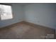 Clean bedroom with a window and neutral carpet at 8915 Touchstone Ln, Charlotte, NC 28227
