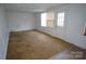 Bright living room with multiple windows and a door offering natural light and outdoor access at 8915 Touchstone Ln, Charlotte, NC 28227