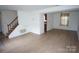 Spacious living room with wood-look floors and staircase at 8915 Touchstone Ln, Charlotte, NC 28227