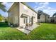 Backyard view featuring patio, lawn, shade trees, and exterior of the home at 110 Hazelton Loop, Mooresville, NC 28117