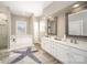 Bright bathroom with double vanity, soaking tub, tiled walk-in shower, and decorative rug at 110 Hazelton Loop, Mooresville, NC 28117