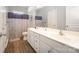 Bright bathroom features double sink, updated vanity, framed mirror, and shower-tub combo at 110 Hazelton Loop, Mooresville, NC 28117