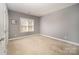 Neutral bedroom with carpeted floors, a large window, and ample space for furniture at 110 Hazelton Loop, Mooresville, NC 28117