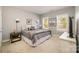 Cozy bedroom with two windows, a queen bed, neutral walls, and carpeted floors at 110 Hazelton Loop, Mooresville, NC 28117