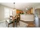 Charming dining area with a wooden table, bench seating, and view of the modern kitchen at 110 Hazelton Loop, Mooresville, NC 28117