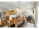 Open-concept dining area with dark wood table and views into a modern living room at 110 Hazelton Loop, Mooresville, NC 28117