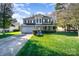 Beautiful two-story home with a lush green lawn, complemented by well-maintained landscaping and mature trees at 110 Hazelton Loop, Mooresville, NC 28117