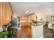 Well-lit kitchen boasting dark countertops, hardwood floors, and modern stainless steel appliances at 110 Hazelton Loop, Mooresville, NC 28117