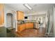 Bright kitchen featuring wood cabinetry, granite countertops, and stainless steel appliances at 110 Hazelton Loop, Mooresville, NC 28117