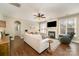 Cozy living room with a fireplace, hardwood floors, and plenty of natural light, perfect for relaxation at 110 Hazelton Loop, Mooresville, NC 28117