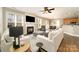 Bright living room featuring a fireplace, ceiling fan, hardwood floors, and an open layout at 110 Hazelton Loop, Mooresville, NC 28117