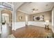 Spacious living room with hardwood floors, white trim, and a large window offering ample light at 110 Hazelton Loop, Mooresville, NC 28117