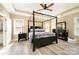 Large main bedroom featuring tray ceilings, ceiling fan, and a four-post bed frame at 110 Hazelton Loop, Mooresville, NC 28117