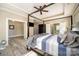 Bright primary bedroom features tray ceiling, four-poster bed, and ensuite bathroom access at 110 Hazelton Loop, Mooresville, NC 28117