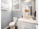 Charming powder room features pedestal sink, framed mirror, and wood-look flooring at 110 Hazelton Loop, Mooresville, NC 28117
