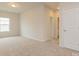 Upstairs bedroom with neutral carpet, natural light, and ensuite bathroom entrance at 1101 Red River Dr, Salisbury, NC 28144