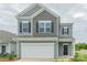 Charming two-story home with a gray exterior, black shutters, white trim, and a two-car garage at 1101 Red River Dr, Salisbury, NC 28144
