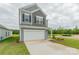 Charming two-story home with gray siding, attached two-car garage and a long concrete driveway at 1101 Red River Dr, Salisbury, NC 28144