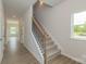 Inviting hallway with wood floors, staircase with decorative metal, and a window that brings in light at 1101 Red River Dr, Salisbury, NC 28144