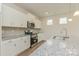 Bright kitchen with white cabinets, granite countertops, a stainless steel sink, and stainless steel appliances at 1101 Red River Dr, Salisbury, NC 28144