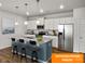This spacious kitchen features white cabinets, stainless steel appliances, and a large island with bar seating at 1101 Red River Dr, Salisbury, NC 28144