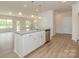 Bright kitchen with white cabinets, granite countertops, stainless steel appliances, and hardwood floors at 1101 Red River Dr, Salisbury, NC 28144