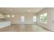 Open-concept living room with light wood floors, recessed lights, and bright windows at 1101 Red River Dr, Salisbury, NC 28144