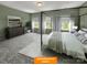 This primary bedroom features a canopy bed, plush carpet, and sun-filled windows at 1101 Red River Dr, Salisbury, NC 28144