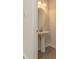 Stylish powder room featuring a pedestal sink, round mirror, wood-look floors, and fresh paint at 1101 Red River Dr, Salisbury, NC 28144