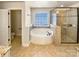 Bathroom featuring a soaking tub and a glass-enclosed shower with tile surround at 11123 River Oaks Nw Dr, Concord, NC 28027