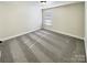 Simple bedroom with neutral carpet, one window, and base trim along the wall at 11123 River Oaks Nw Dr, Concord, NC 28027