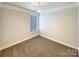 Neutral-toned bedroom with plush carpet and a bright window with blinds at 11123 River Oaks Nw Dr, Concord, NC 28027