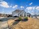 Two-story house with manicured landscaping, beautiful skies, and a sidewalk at 11123 River Oaks Nw Dr, Concord, NC 28027