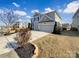 Two-story home with three-car garage, manicured lawn, and well-maintained landscaping at 11123 River Oaks Nw Dr, Concord, NC 28027