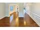 Spacious hallway with hardwood floors, decorative molding, and access to multiple rooms at 11123 River Oaks Nw Dr, Concord, NC 28027