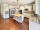 Bright kitchen with stainless steel appliances, granite countertops, and hardwood floors at 11123 River Oaks Nw Dr, Concord, NC 28027