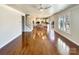 Open-concept living room with hardwood floors leading to the kitchen and staircase at 11123 River Oaks Nw Dr, Concord, NC 28027