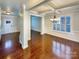 Bright living room features hardwood floors, coffered ceilings, and large window with plantation shutters at 11123 River Oaks Nw Dr, Concord, NC 28027