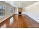 Living room features hardwood floors, built-in shelves, and a stacked stone fireplace at 11123 River Oaks Nw Dr, Concord, NC 28027