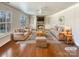 Bright living room with hardwood floors, built-in shelves, a fireplace, and neutral furniture at 11123 River Oaks Nw Dr, Concord, NC 28027
