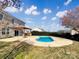 Backyard features in-ground pool, lush landscaping, and pergola covered patio at 11123 River Oaks Nw Dr, Concord, NC 28027