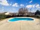 Backyard featuring an in-ground pool with concrete surround and mature landscaping at 11123 River Oaks Nw Dr, Concord, NC 28027