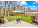 Outdoor seating on a patio offers peaceful enjoyment of the well-maintained backyard at 1116 Berry Ridge Rd, Charlotte, NC 28270