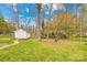 A spacious backyard area features a small shed and well maintained lawn at 1116 Berry Ridge Rd, Charlotte, NC 28270