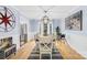 Dining room with a wood table, white chairs, view to the kitchen, and modern light fixture at 1116 Berry Ridge Rd, Charlotte, NC 28270
