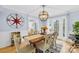 Elegant dining room featuring a farmhouse table, modern light fixture, and access to the kitchen at 1116 Berry Ridge Rd, Charlotte, NC 28270